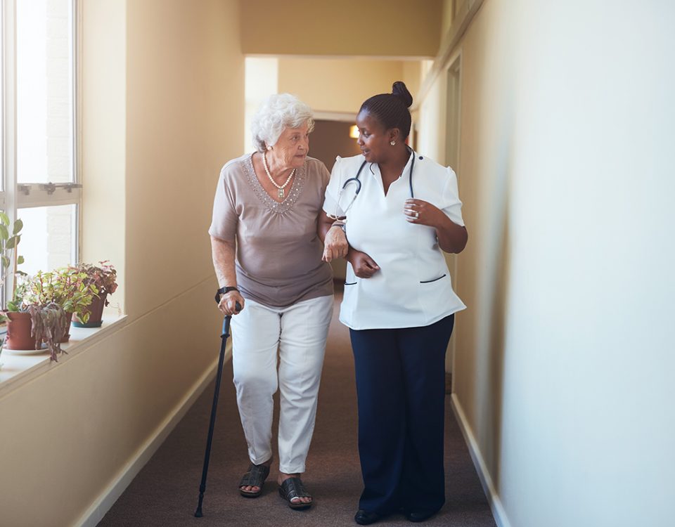 Older woman walking with doctor