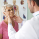 Doctor examining patient's neck