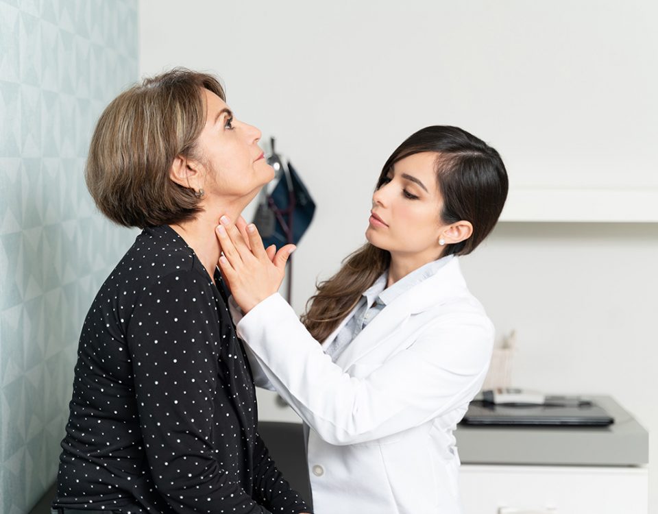 Doctor feels patient's throat