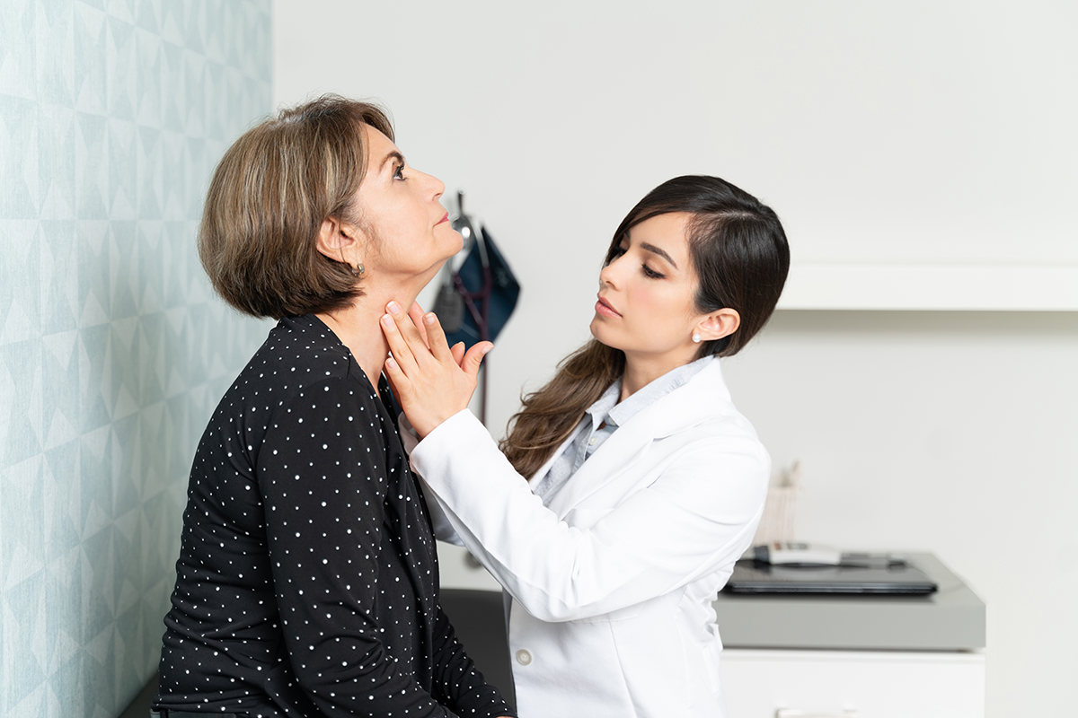 Doctor examining patient's neck