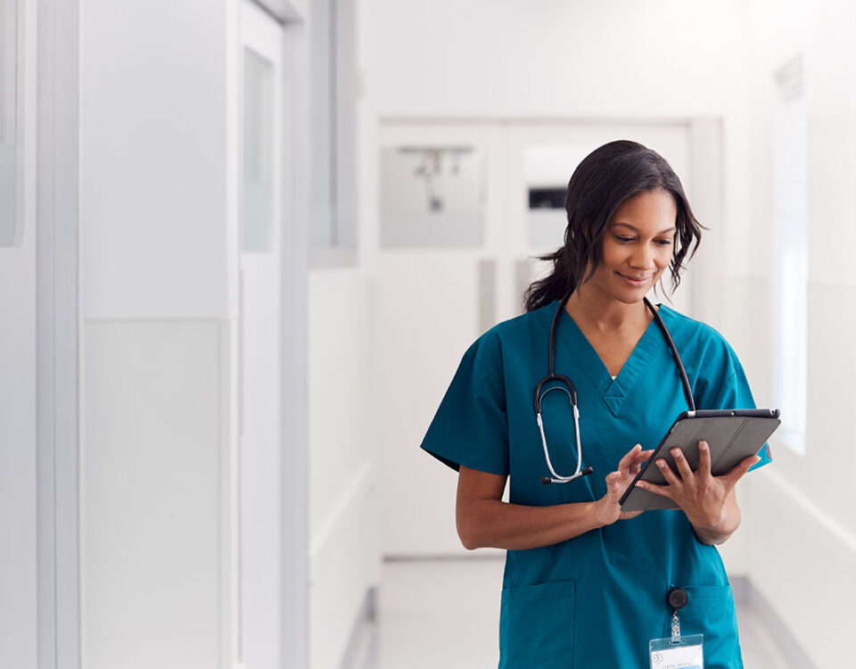 Female doctor in scrubs on iPad
